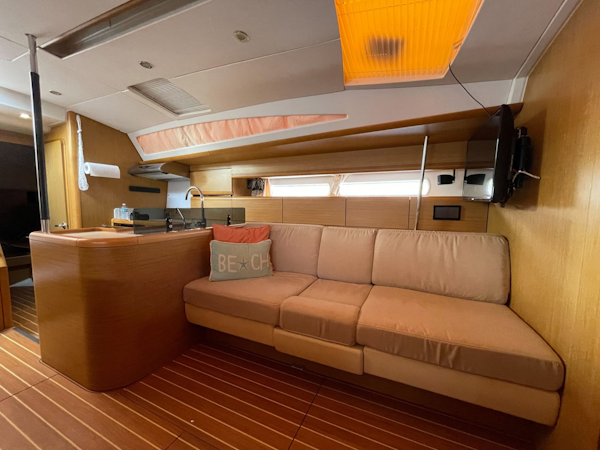 Jeanneau-53 2010 -Key Largo-Florida-United States-Large Settee is to Port with a Fold Down Cocktail Table Exposing a Custom Bar with Bottle Storage-1818188