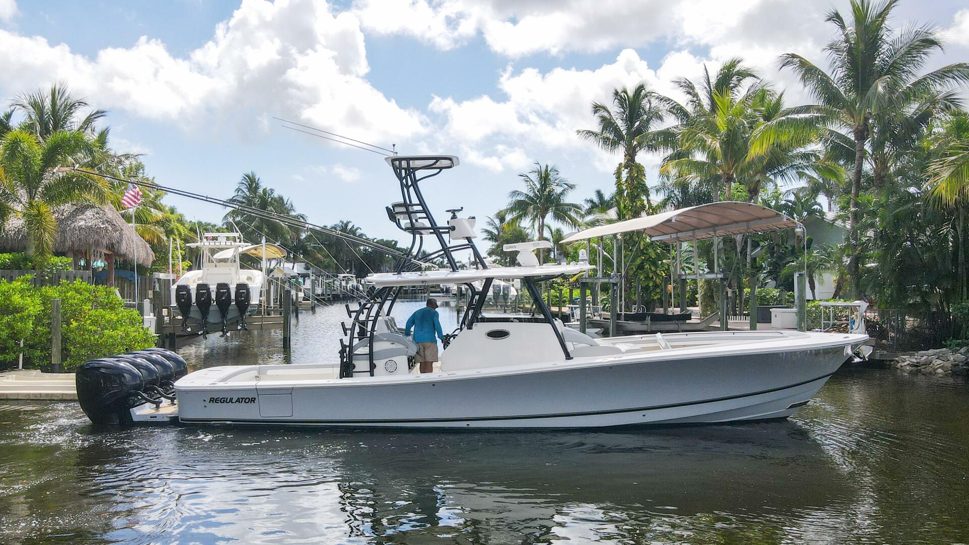 Regulator-41 2020-Grey Hull Stuart-2020 Regulator 41 boat docked in a tropical marina with palm trees.-4946314 | Thumbnail