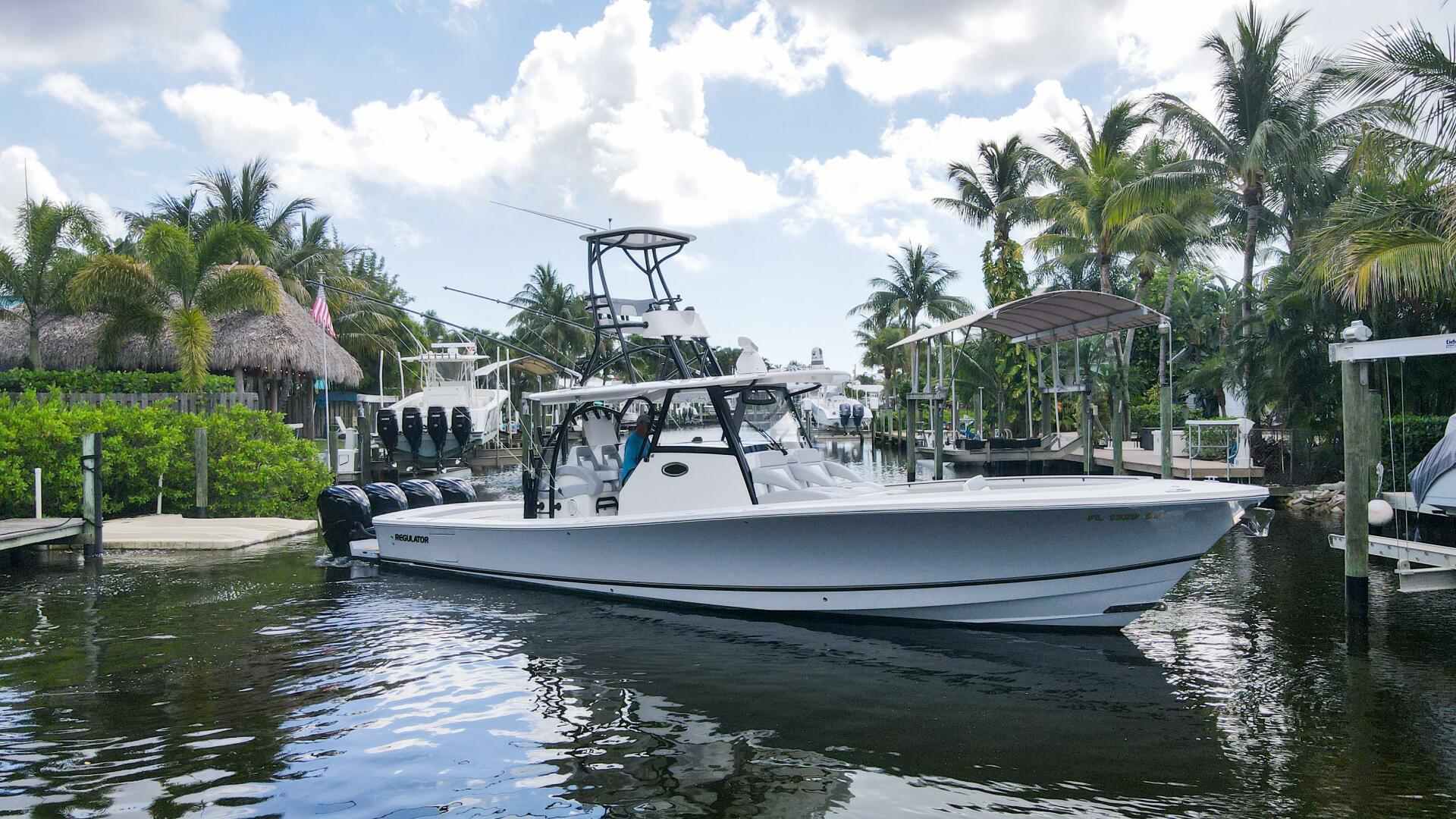 Regulator-41 2020-Grey Hull Stuart-2020 Regulator 41 boat docked in a tropical marina with palm trees.-4946313 | Thumbnail