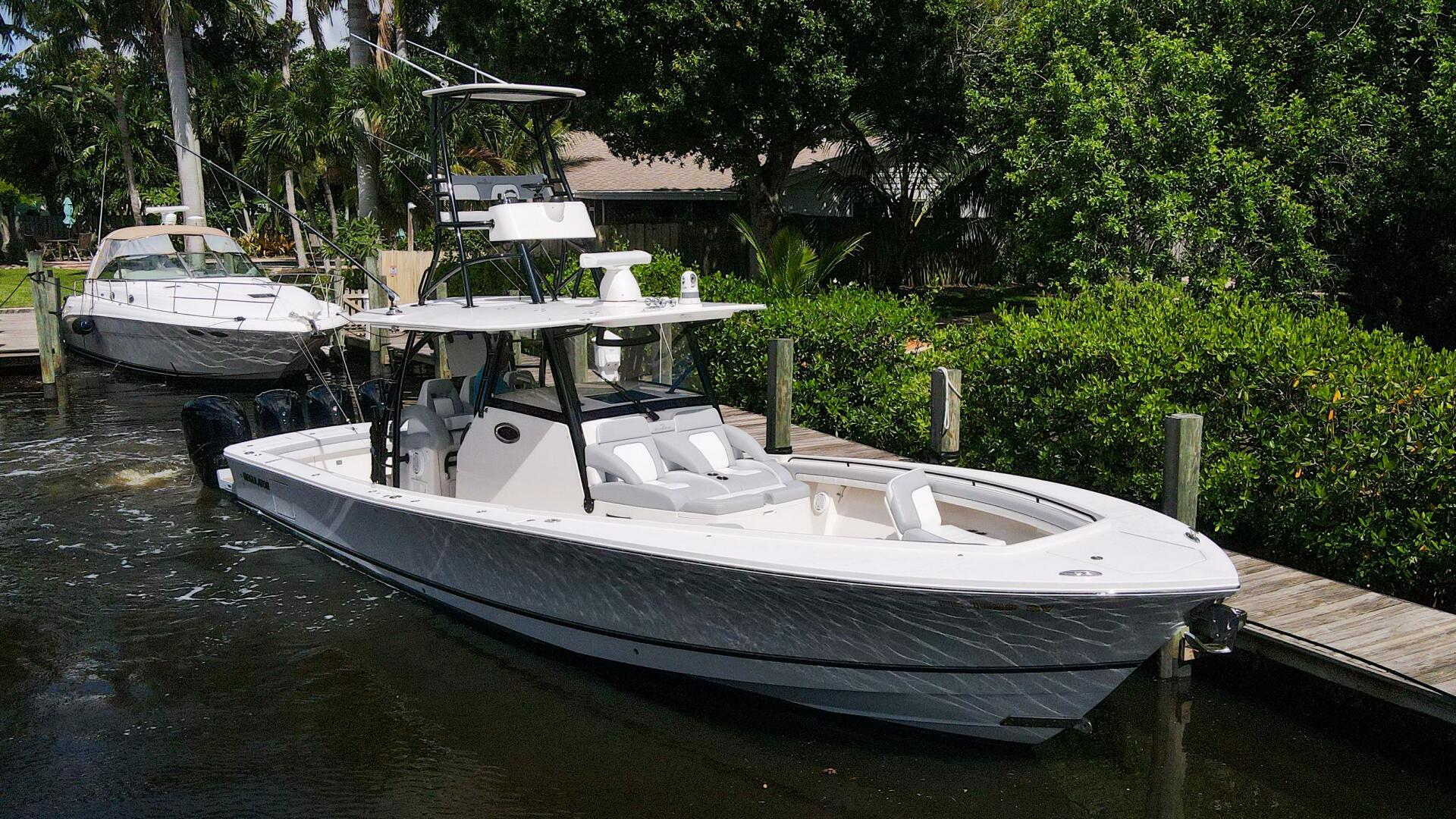Regulator-41 2020-Grey Hull Stuart-2020 Regulator 41 boat docked in a marina with lush greenery.-4946311 | Thumbnail