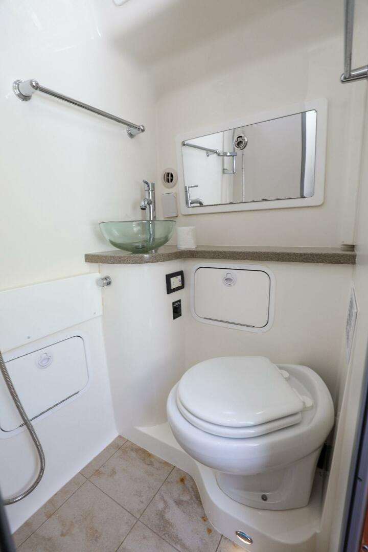 Regulator-41 2020-Grey Hull Stuart-2020 Regulator 41 boat bathroom with modern fixtures and glass sink.-4946339 | Thumbnail
