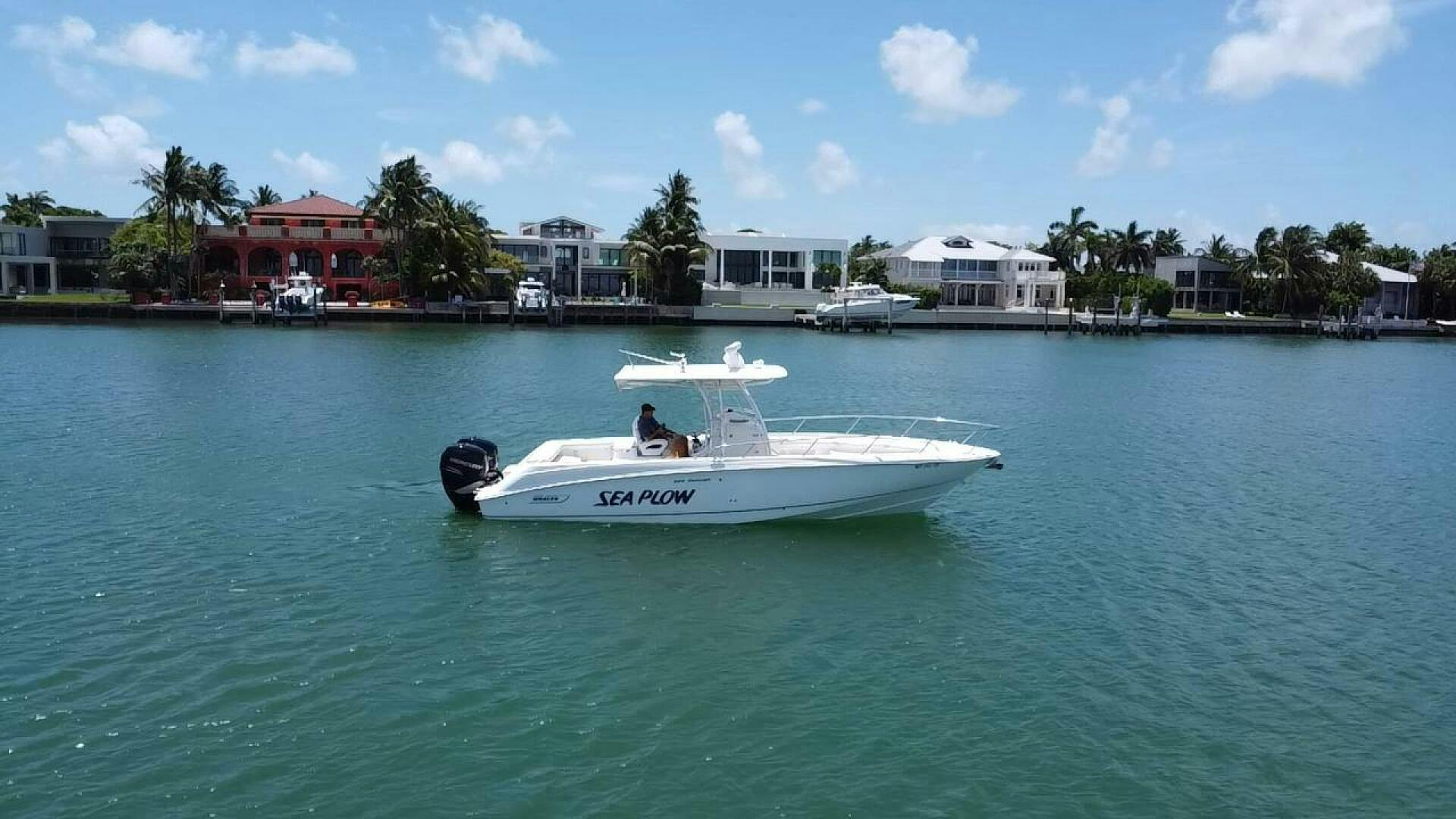 Boston Whaler-320 Outrage 2008 -Stuart-2008 Boston Whaler 320 Outrage boat named Sea Plow on calm water near waterfront homes.-4946987