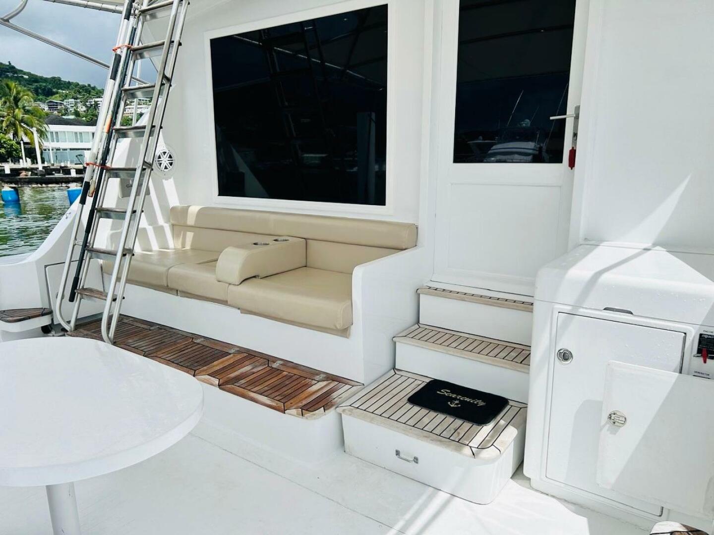 Bertram-54 1988 -Stuart-1988 Bertram 54 yacht deck with seating, ladder, and steps in a marina setting.-4947211 | Thumbnail