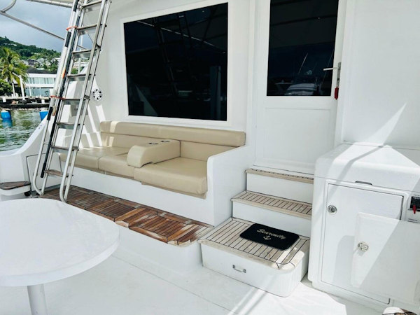 Bertram-54 1988 -Stuart-1988 Bertram 54 yacht deck with seating, ladder, and steps in a marina setting.-4947211