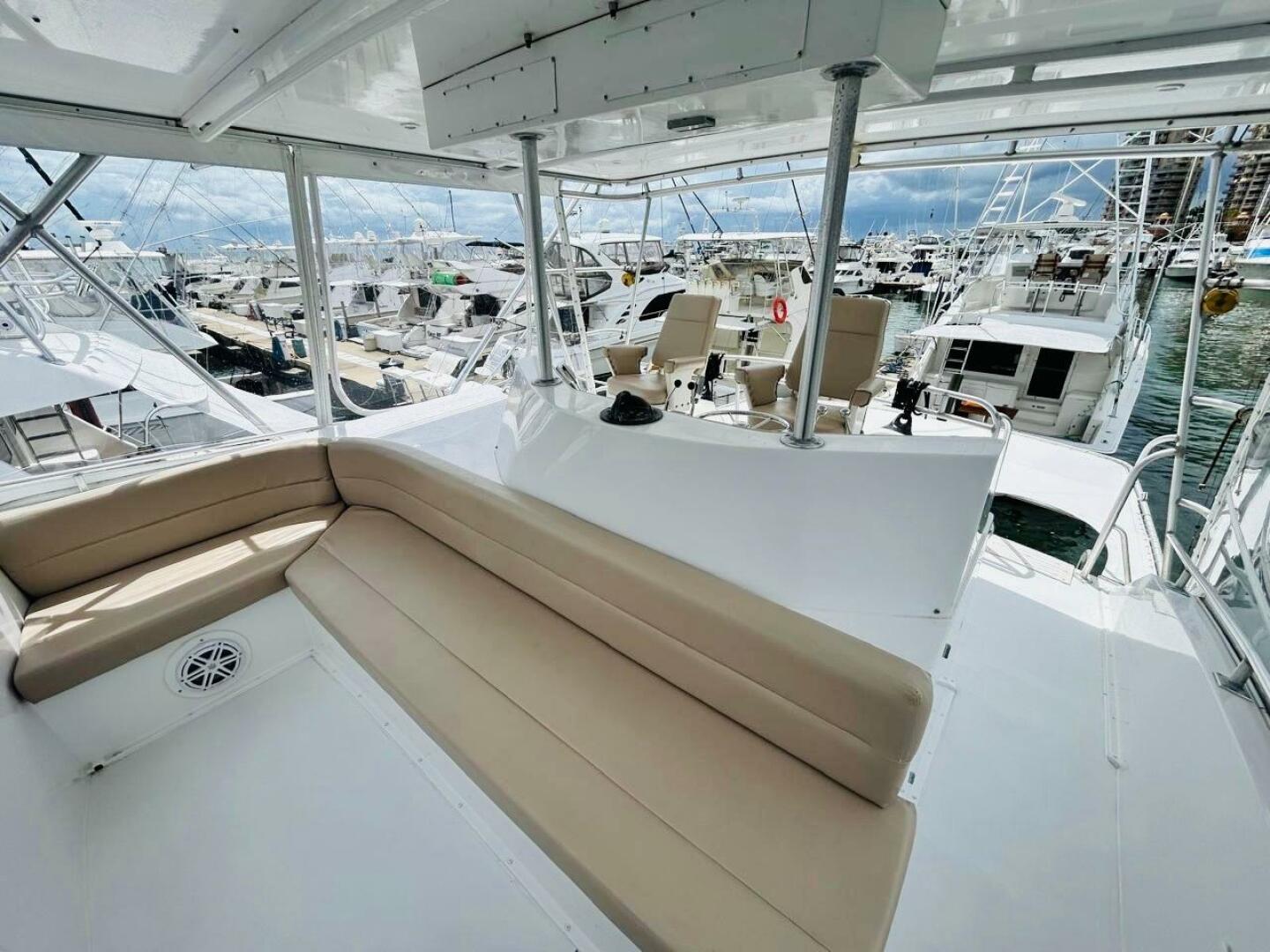 Bertram-54 1988 -Stuart-1988 Bertram 54 yacht interior with seating, docked among other boats.-4947246 | Thumbnail