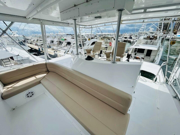 Bertram-54 1988 -Stuart-1988 Bertram 54 yacht interior with seating, docked among other boats.-4947246