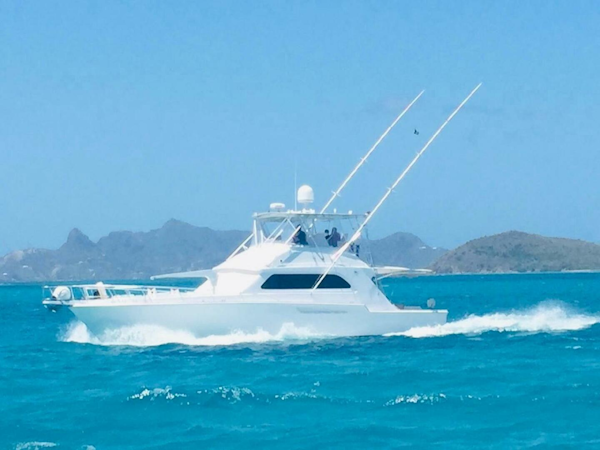 Bertram-54 1988 -Stuart-1988 Bertram 54 yacht cruising in turquoise waters with scenic island backdrop.-4947204