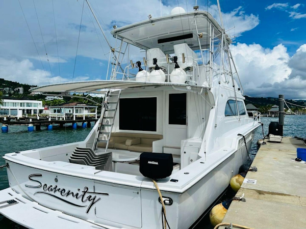 Bertram-54 1988 -Stuart-1988 Bertram 54 yacht Serenity docked at marina under blue sky.-4947206