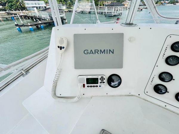 Bertram-54 1988 -Stuart-Bertram 54 1988 yacht helm with Garmin navigation system and radio controls.-4947245