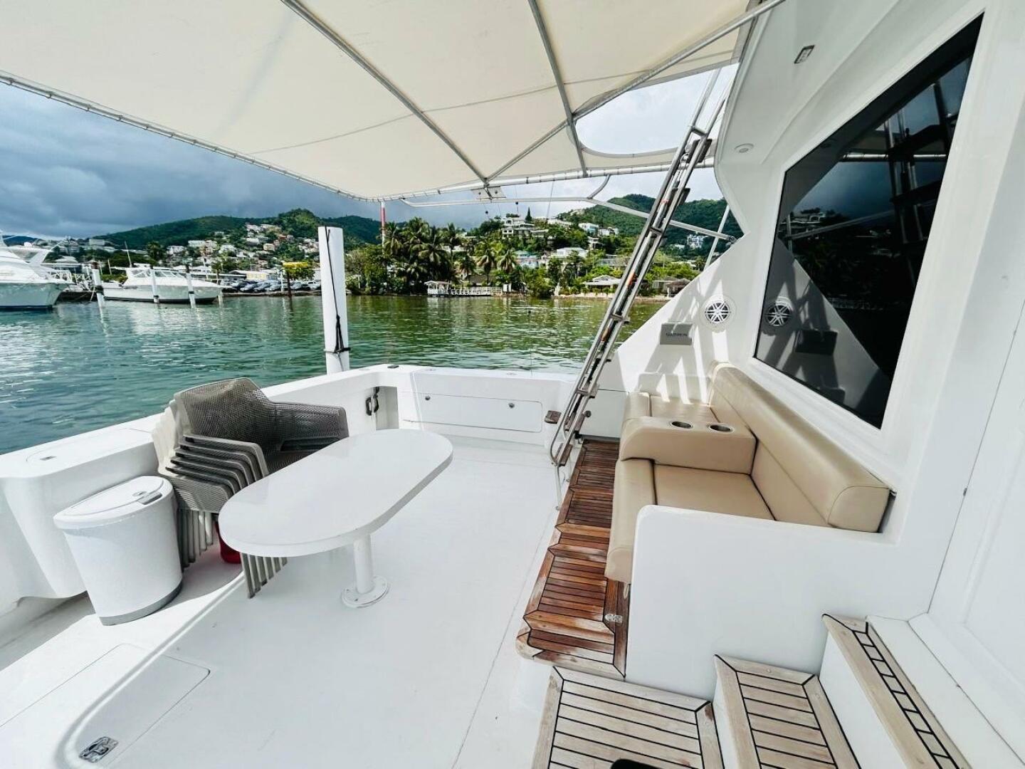 Bertram-54 1988 -Stuart-1988 Bertram 54 yacht deck with seating, table, and scenic marina view.-4947233 | Thumbnail