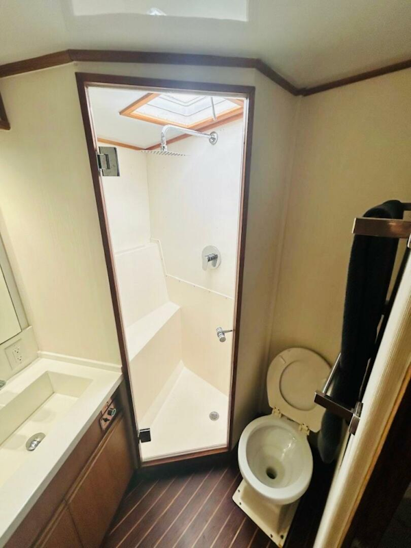 Bertram-54 1988 -Stuart-1988 Bertram 54 yacht bathroom with shower, toilet, and sink.-4947220