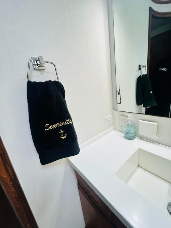 Bertram-54 1988 -Stuart-Bathroom interior of 1988 Bertram 54 yacht with Searenity towel and modern sink.-4947217