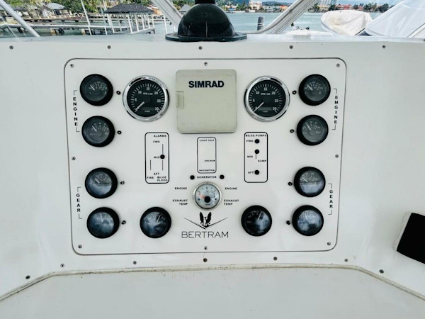 Bertram-54 1988 -Stuart-Control panel of a 1988 Bertram 54 yacht with gauges and Simrad equipment.-4947244