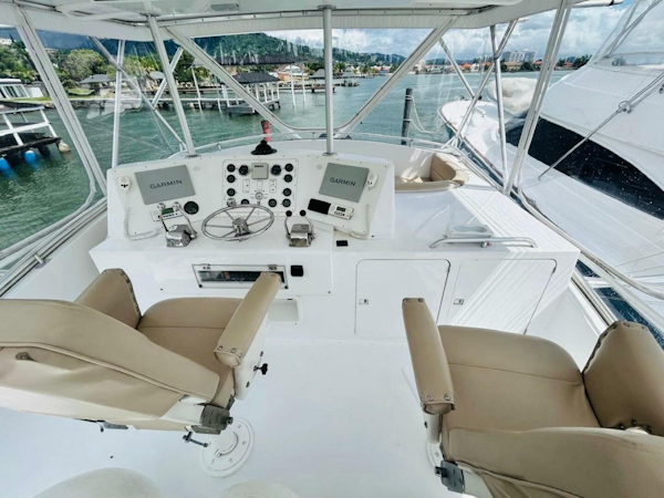 Bertram-54 1988 -Stuart-1988 Bertram 54 yacht helm with dual Garmin displays and beige captain chairs.-4947242