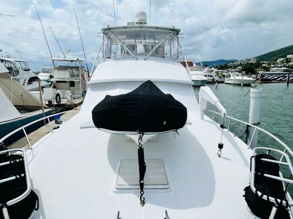 Bertram-54 1988 -Stuart-1988 Bertram 54 yacht docked at marina, featuring spacious deck and covered equipment.-4947235