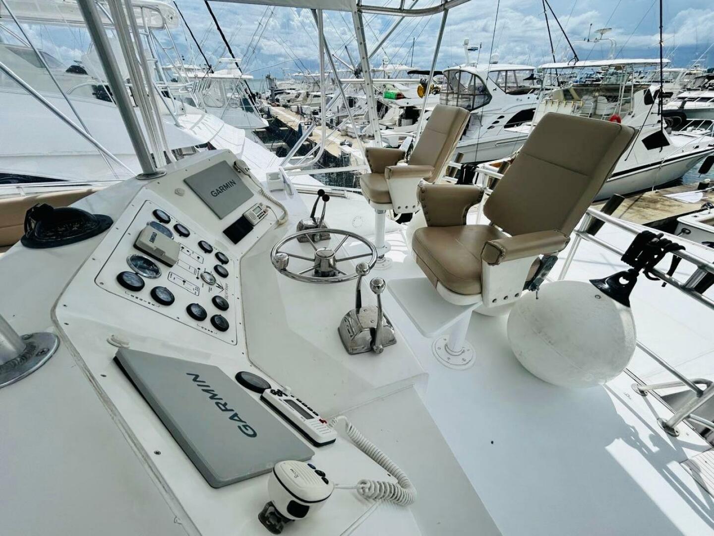 Bertram-54 1988 -Stuart-Cockpit of 1988 Bertram 54 yacht with Garmin navigation, docked at marina.-4947241 | Thumbnail