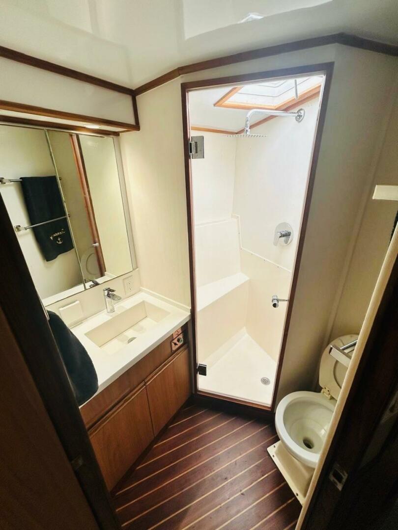 Bertram-54 1988 -Stuart-1988 Bertram 54 yacht bathroom with shower, sink, and toilet.-4947213 | Thumbnail