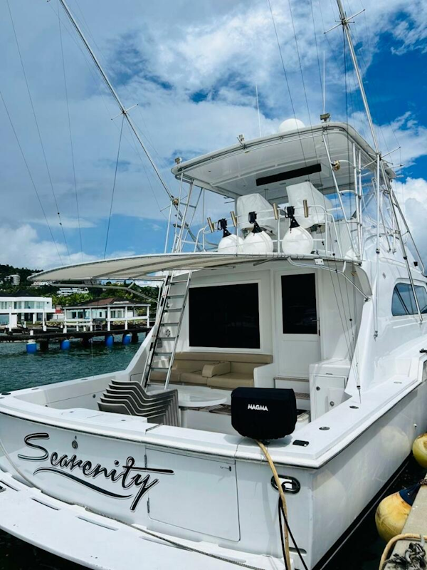 Bertram-54 1988 -Stuart-1988 Bertram 54 yacht docked, featuring spacious deck and fishing equipment.-4947201
