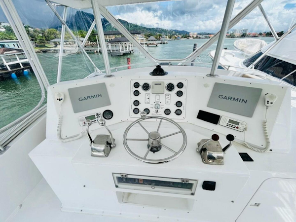 Bertram-54 1988 -Stuart-1988 Bertram 54 yacht helm with Garmin navigation, dual controls, and scenic marina view.-4947243