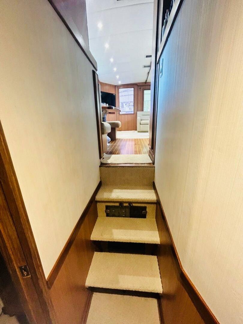 Bertram-54 1988 -Stuart-Interior view of 1988 Bertram 54 yacht, featuring carpeted stairs and wood-paneled walls.-4947214 | Thumbnail