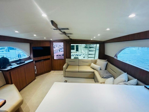 Bertram-54 1988 -Stuart-Luxurious interior of 1988 Bertram 54 yacht with modern furnishings and large windows.-4947225