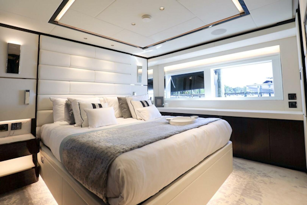 Majesty Yachts-120 2025-Fractional Ownership Available Stuart-Florida-United States-Luxurious bedroom interior on 2025 Majesty 120 yacht, featuring elegant design and large window.-4947561