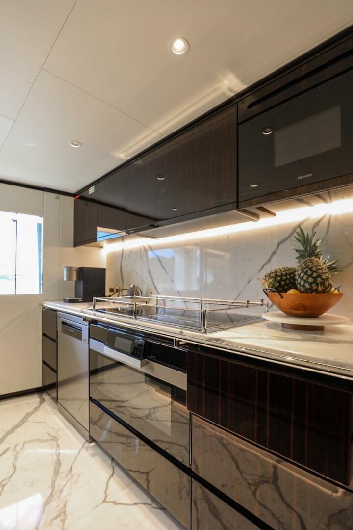 Majesty Yachts-120 2025-Fractional Ownership Available Stuart-Florida-United States-Luxurious kitchen in 2025 Majesty 120 yacht with sleek cabinets and marble flooring.-4947543 | Thumbnail