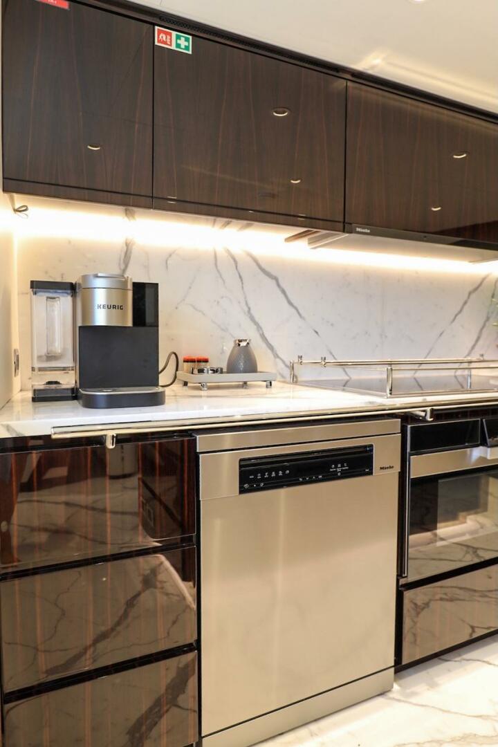 Majesty Yachts-120 2025-Fractional Ownership Available Stuart-Florida-United States-Modern kitchen with marble backsplash, sleek cabinetry, and high-end appliances on a Majesty 120 yacht.-4947547 | Thumbnail