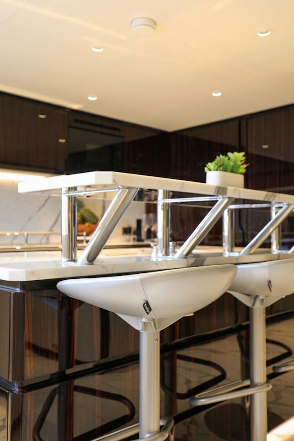 Majesty Yachts-120 2025-Fractional Ownership Available Stuart-Florida-United States-Modern kitchen interior with sleek bar stools and contemporary design, Majesty 120 yacht, 2025 model.-4947542