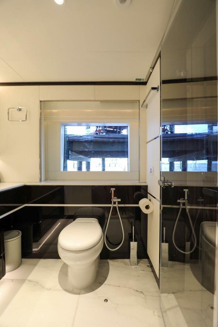 Majesty Yachts-120 2025-Fractional Ownership Available Stuart-Florida-United States-Luxurious bathroom in 2025 Majesty 120 yacht with modern fixtures and large window.-4947554 | Thumbnail