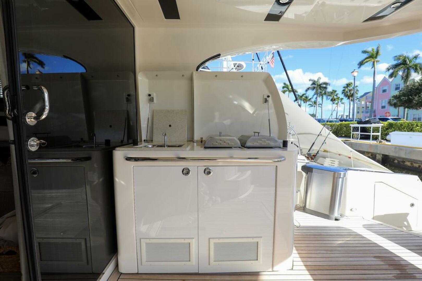 Marquis-660 Sport Yacht 2016 -Stuart-Outdoor kitchenette on 2016 Marquis 660 Sport Yacht with palm trees in background.-4947635 | Thumbnail