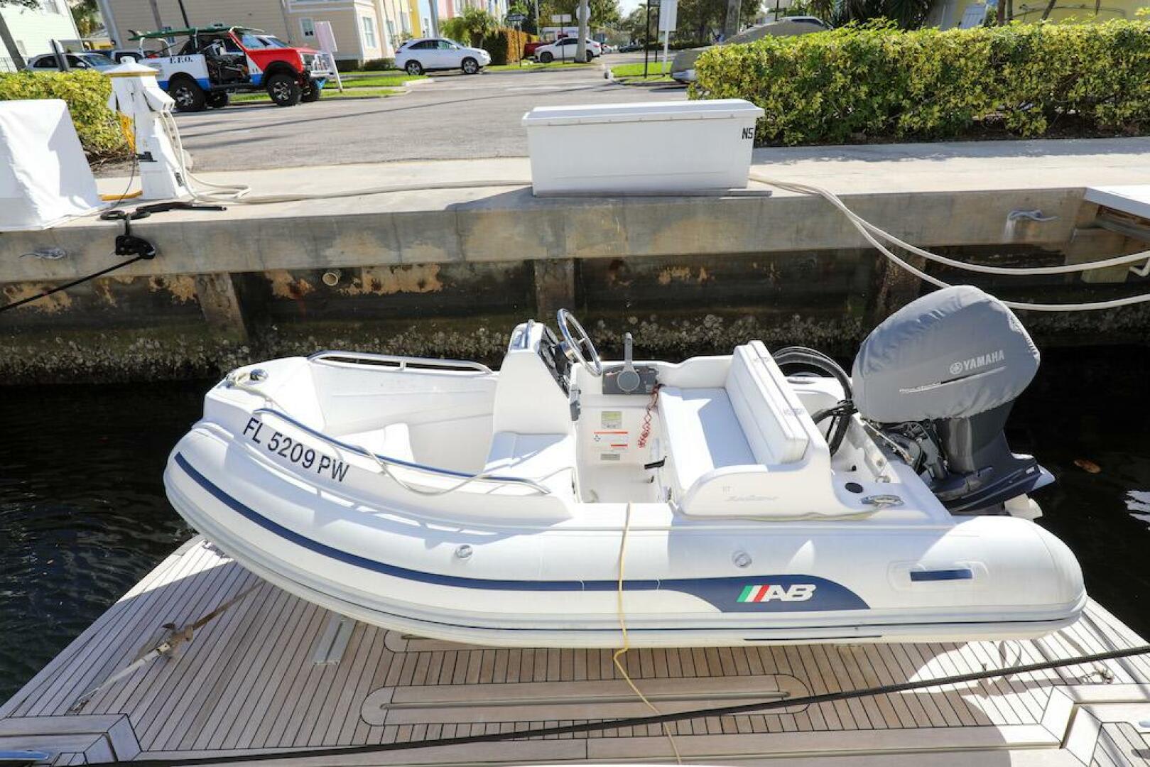 Marquis-660 Sport Yacht 2016 -Stuart-White inflatable boat docked, featuring a Yamaha motor, near a 2016 Marquis 660 Sport Yacht.-4947639 | Thumbnail