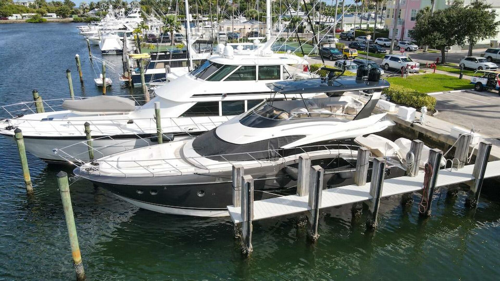 Marquis-660 Sport Yacht 2016 -Stuart-2016 Marquis 660 Sport Yacht docked at marina, surrounded by other boats.-4947607 | Thumbnail