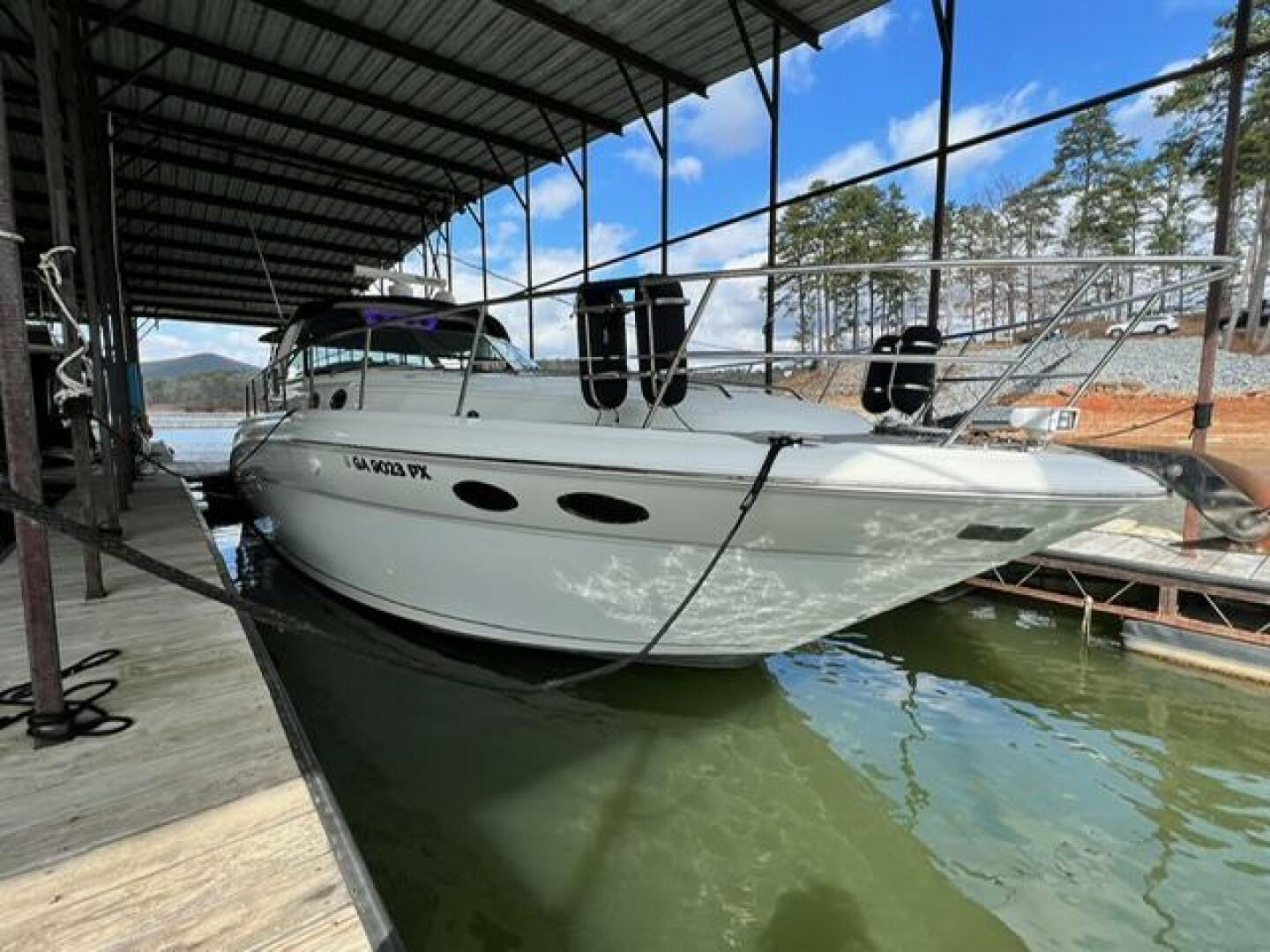 Sea Ray-380 Sundancer 2003 -Stuart-2003 Sea Ray 380 Sundancer docked under a covered marina with scenic background.-5185245 | Thumbnail