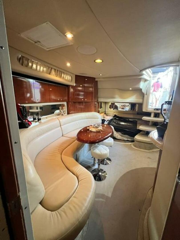 Sea Ray-380 Sundancer 2003 -Stuart-2003 Sea Ray 380 Sundancer interior with curved seating and wooden table.-5185257