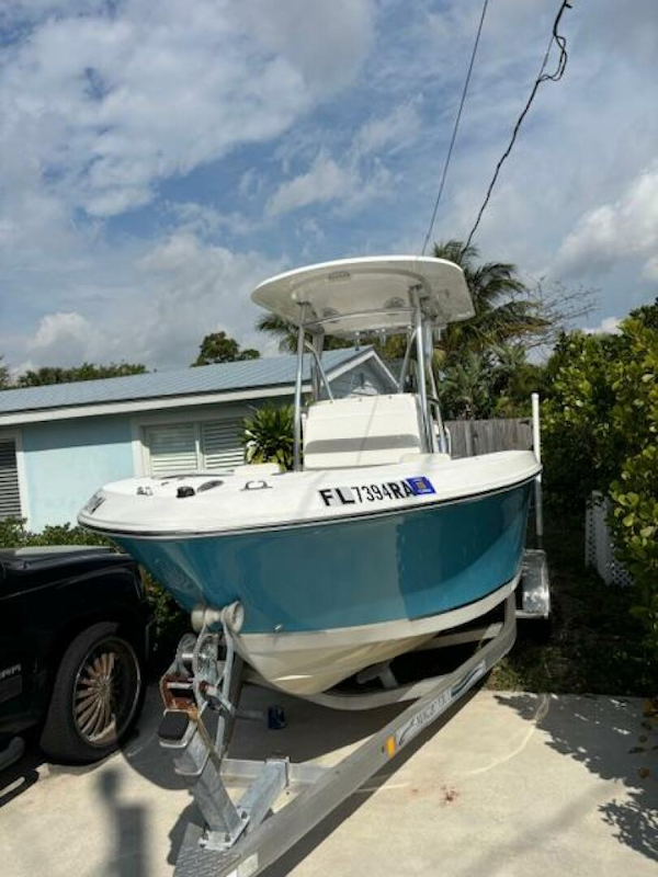 Release-208 RX 2016 -Stuart-2016 Release 208 RX boat on trailer, parked in driveway, under cloudy sky.-5114910