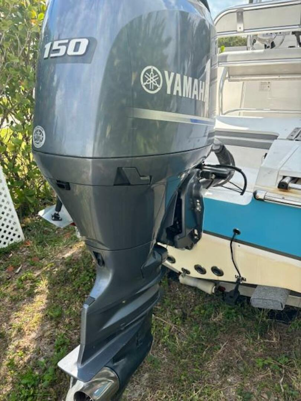 Release-208 RX 2016 -Stuart-Yamaha 150 outboard motor on 2016 Release 208 RX boat, parked on grass.-5114916