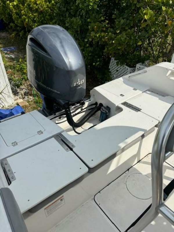 Release-208 RX 2016 -Stuart-2016 Release 208 RX boat with Yamaha 150 outboard motor, docked near greenery.-5114928