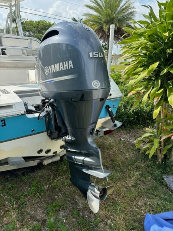 Release-208 RX 2016 -Stuart-2016 Release 208 RX boat with Yamaha 150 outboard motor, parked outdoors.-5114915