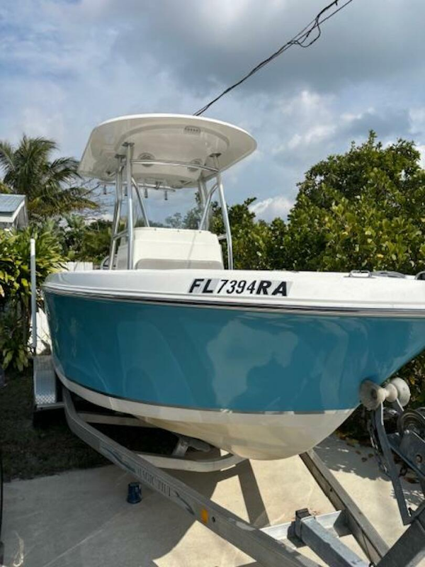 Release-208 RX 2016 -Stuart-2016 Release 208 RX boat on trailer, blue hull, parked outdoors.-5114911