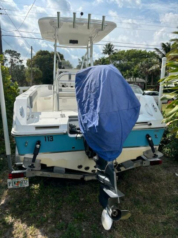 Release-208 RX 2016 -Stuart-2016 Release 208 RX boat with covered motor, parked on grass.-5114914