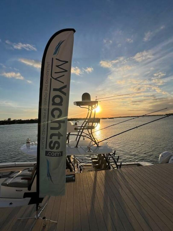 Regulator-41 2024-Fractional Ownership Available Stuart-2024 Regulator 41 yacht at sunset, docked with MyYachts.com banner.-5234040