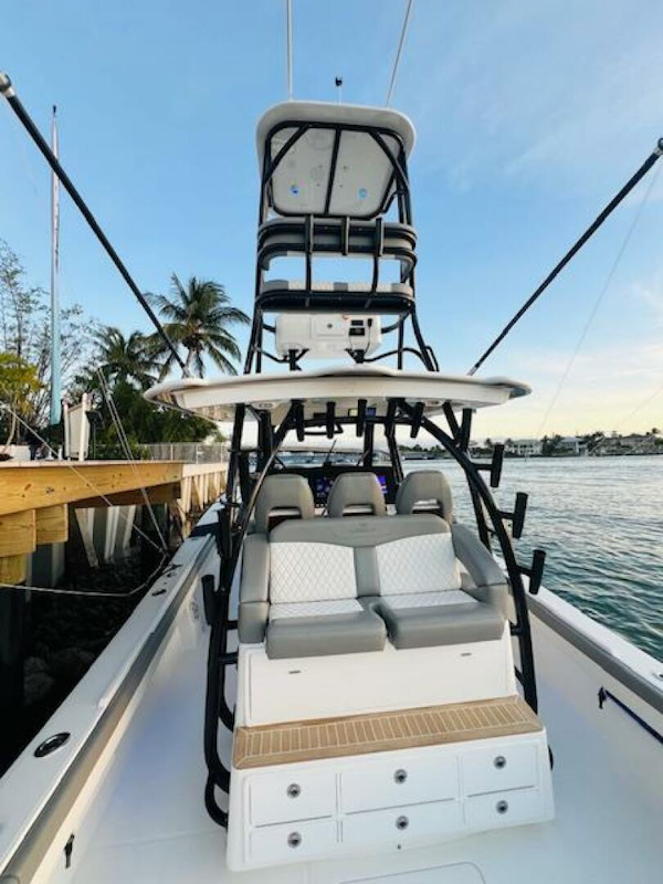 Regulator-41 2024-Fractional Ownership Available Stuart-2024 Regulator 41 boat with tower, docked by the water, featuring seating and storage.-5234056