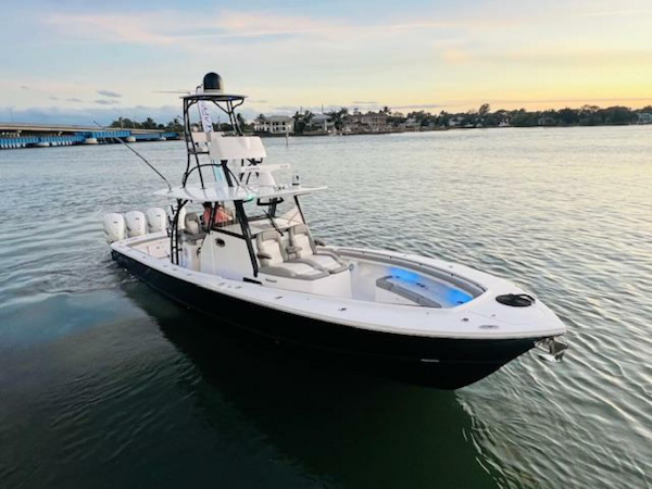 Regulator-41 2024-Fractional Ownership Available Stuart-2024 Regulator 41 boat on calm water at sunset.-5234058