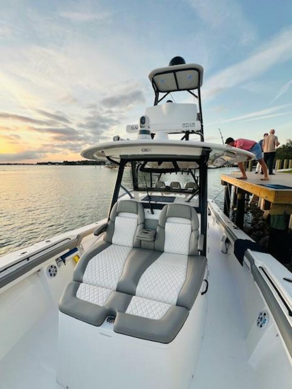 Regulator-41 2024-Fractional Ownership Available Stuart-2024 Regulator 41 boat with luxurious seating, docked at sunset.-5234047