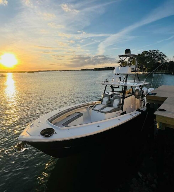 Regulator-41 2024-Fractional Ownership Available Stuart-2024 Regulator 41 boat docked at sunset, calm waters, scenic view.-5234042
