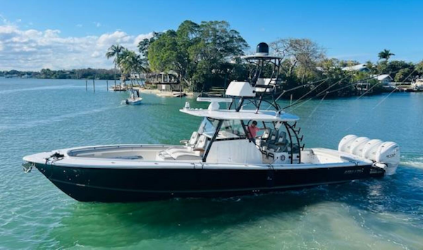 Regulator-41 2024-Fractional Ownership Available Stuart-2024 Regulator 41 boat on clear water with lush greenery in the background.-5234029