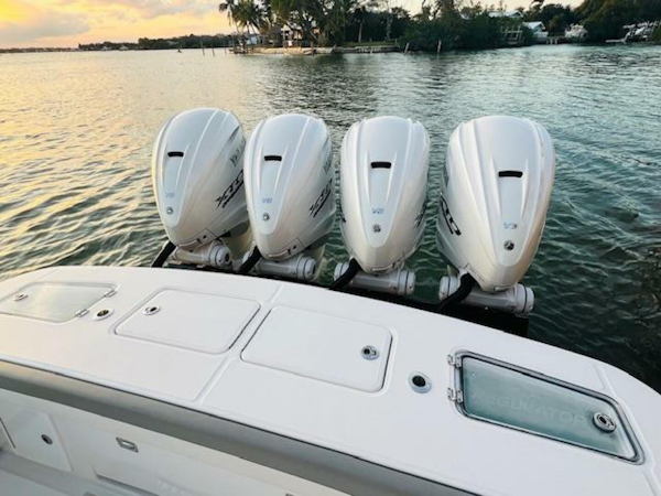 Regulator-41 2024-Fractional Ownership Available Stuart-2024 Regulator 41 boat with four powerful outboard engines on a serene water backdrop.-5234043