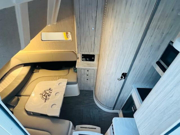 Regulator-41 2024-Fractional Ownership Available Stuart-2024 Regulator 41 cabin interior with modern seating, table, and wood paneling.-5234044