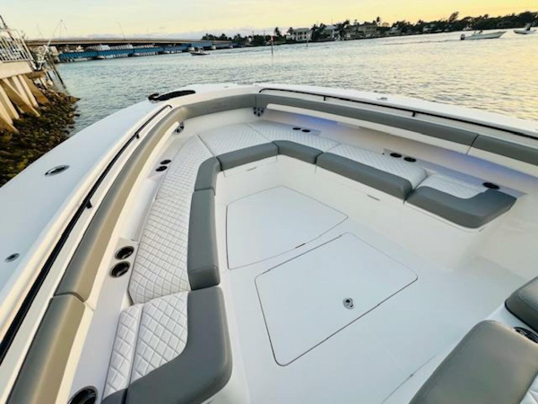 Regulator-41 2024-Fractional Ownership Available Stuart-2024 Regulator 41 boat with spacious seating, docked by the water at sunset.-5234048